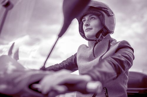 Frau mit Helm auf Roller